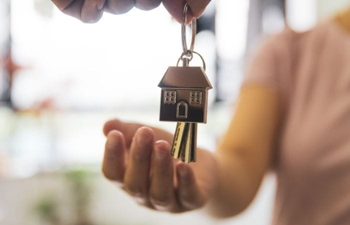 a-person-receiving-a-key-to-her-house