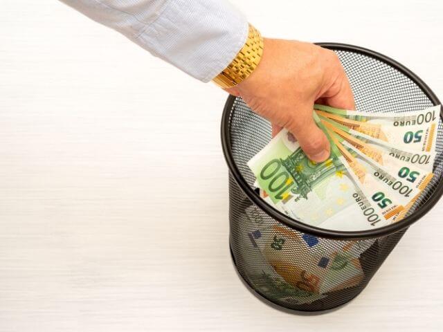a-person-throwing-money-into-a-bin